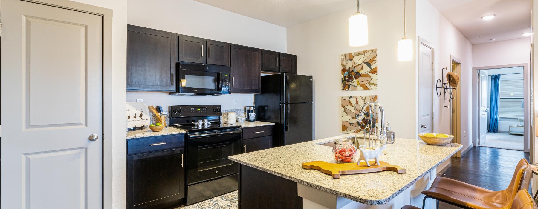a kitchen with black cabinets