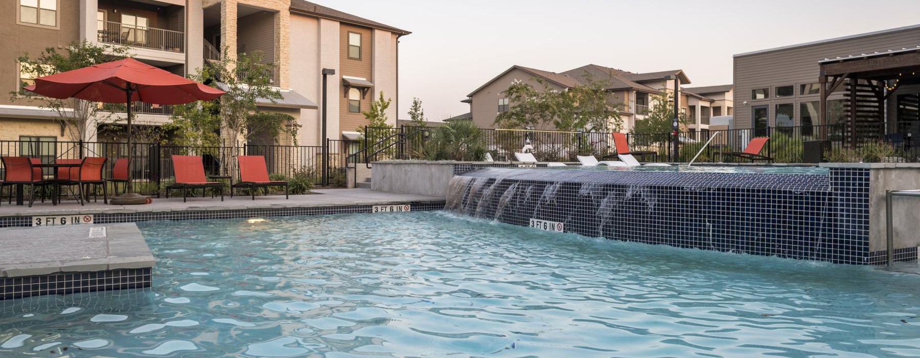 a swimming pool with a building in the background