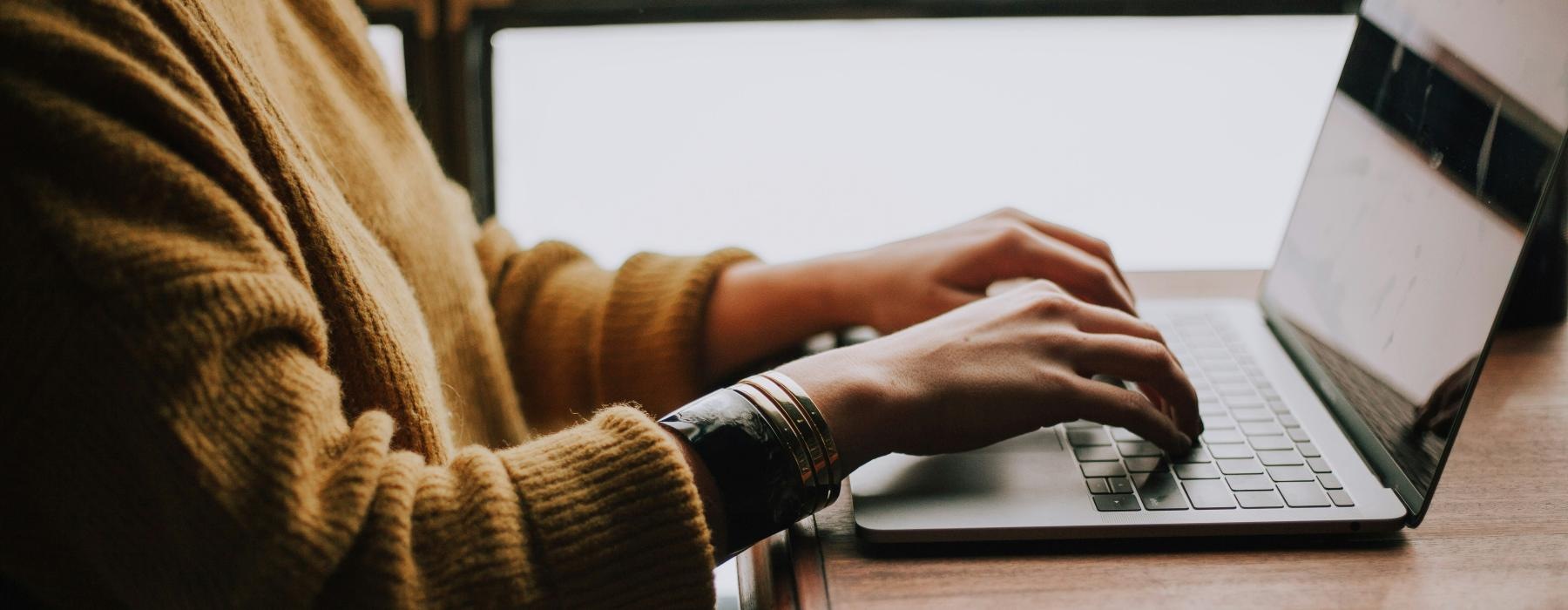 a person typing on a laptop