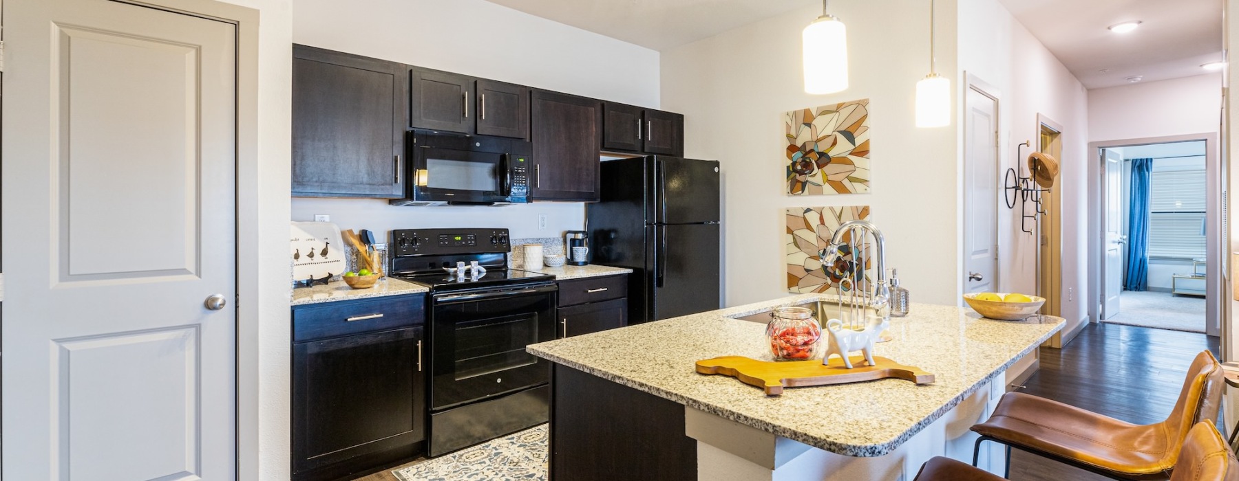 a kitchen with black cabinets