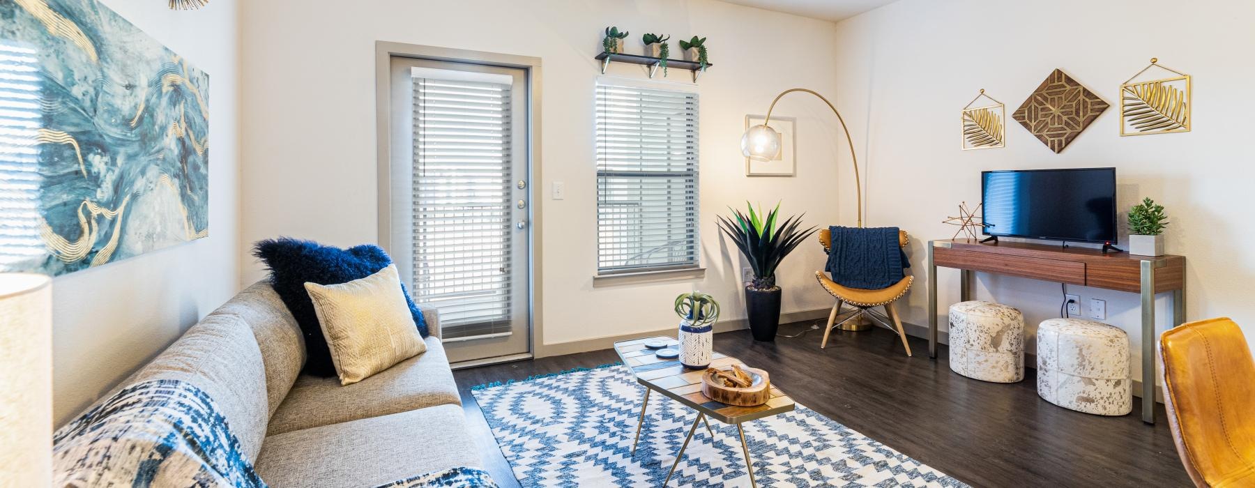 a living room with a fan and a couch