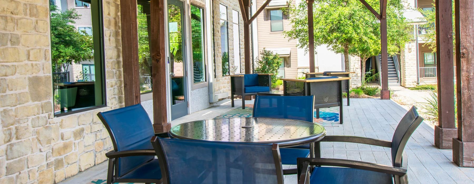 a patio with tables and chairs